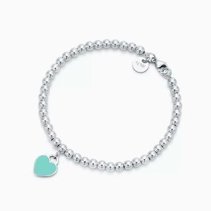 Tiffany & Co. Silver Bead Bracelet with Blue Heart Charm